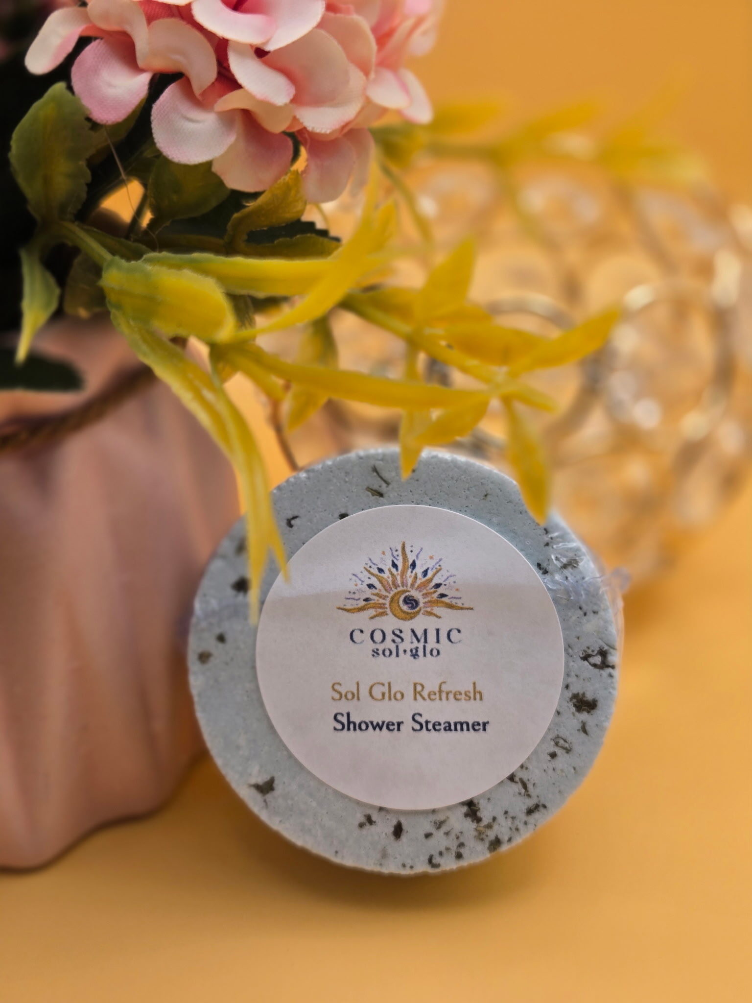 Sol Glo Refresh shower steamer with a speckled texture, labeled Cosmic Sol Glo
